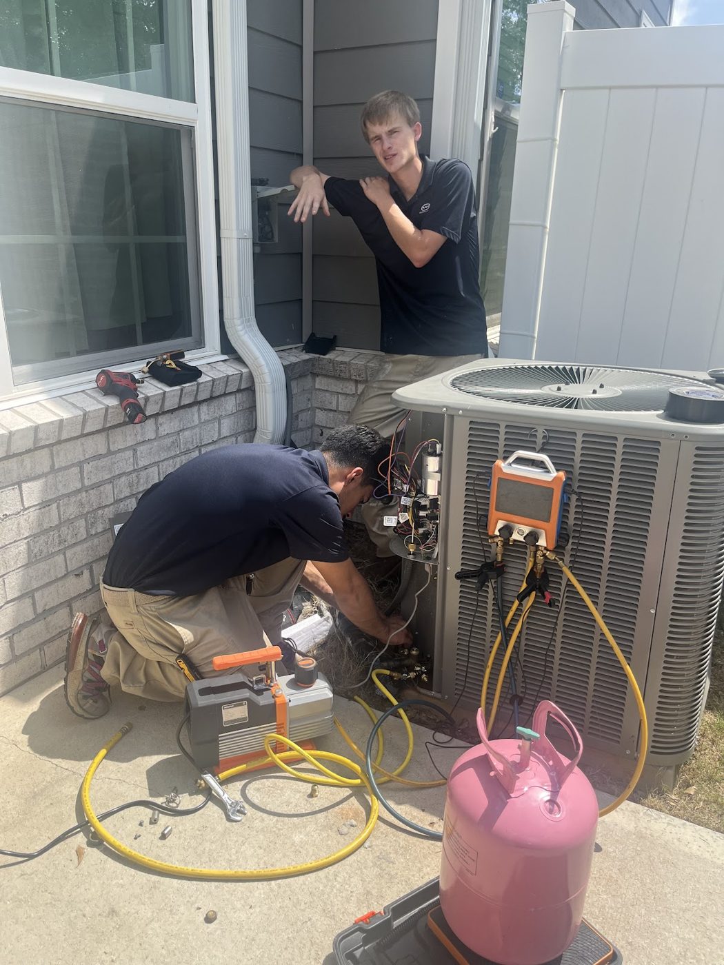 RGP technicians servicing an AC unit